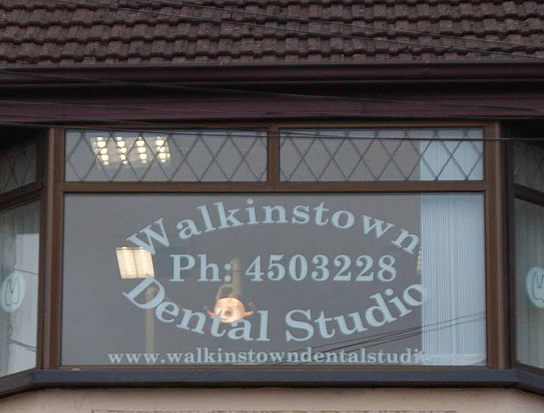 Walkinstown Dental Studio window pane with contact details superimposed