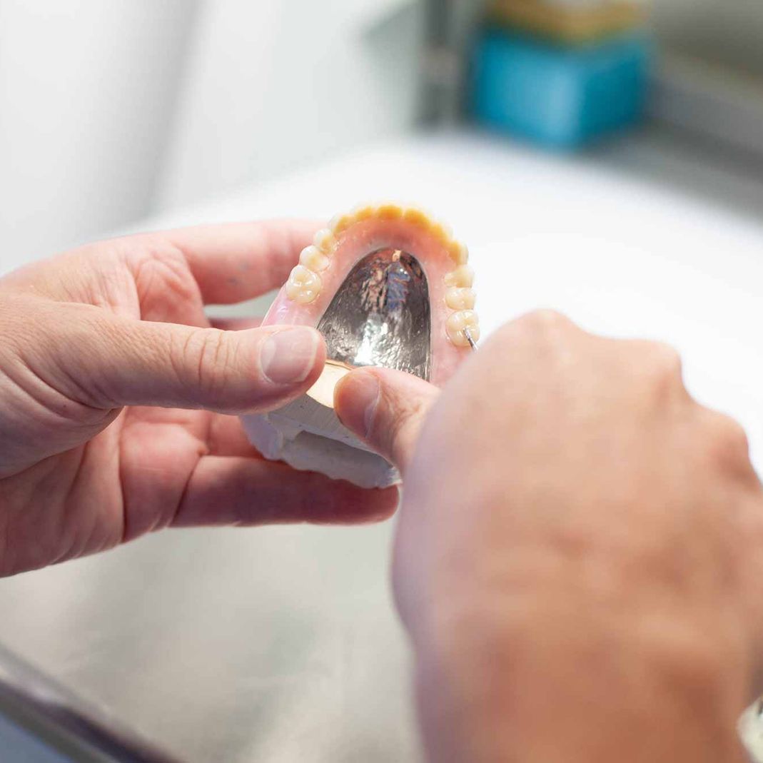 Dentist working on dentures at Walkinstown Dental Studio